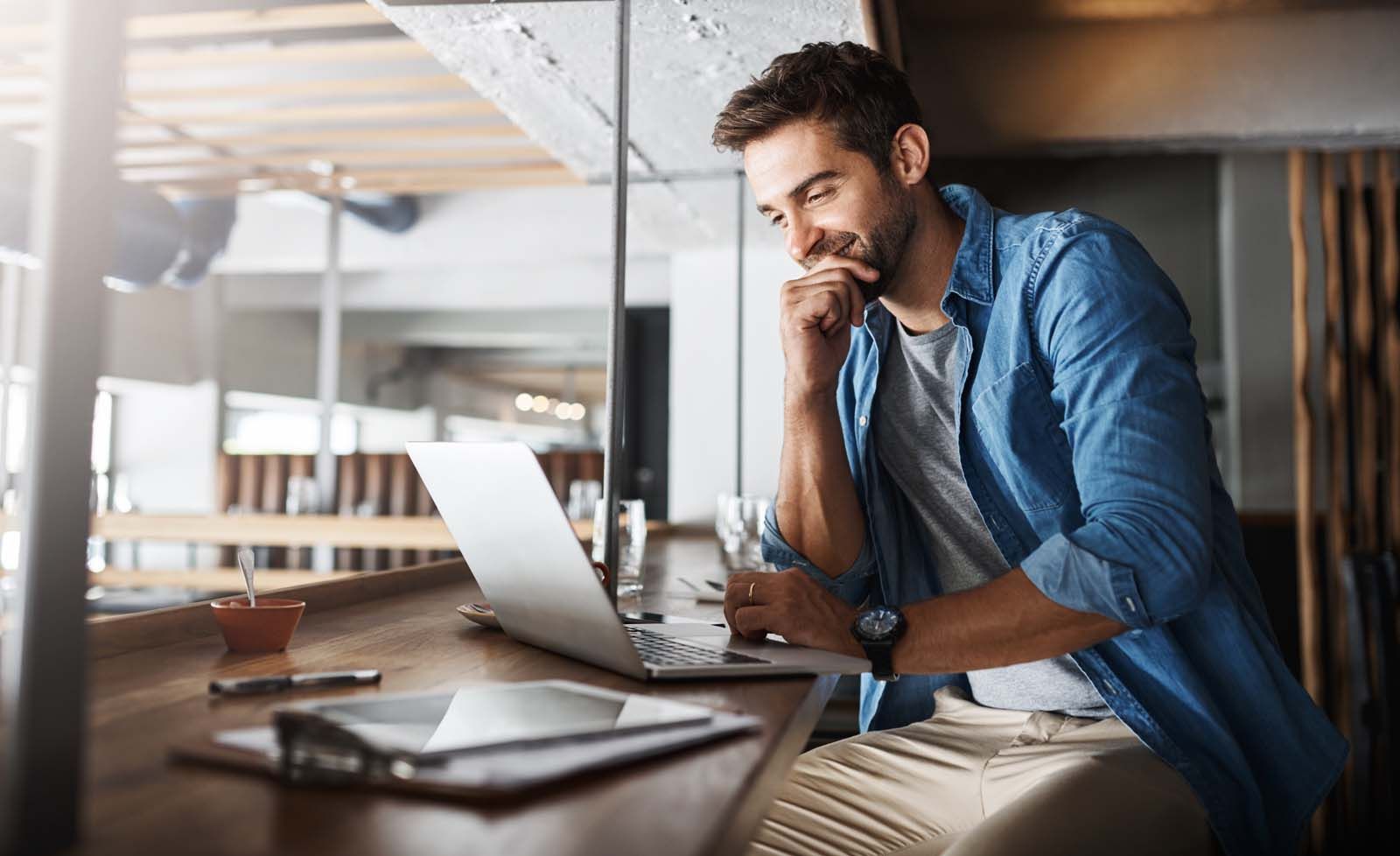 Man smiling at laptop